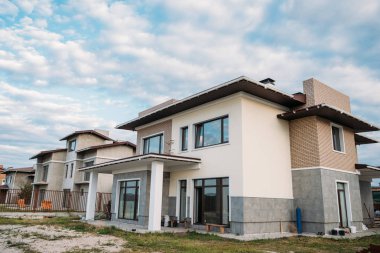 newly constructed building under cloudy sky clipart