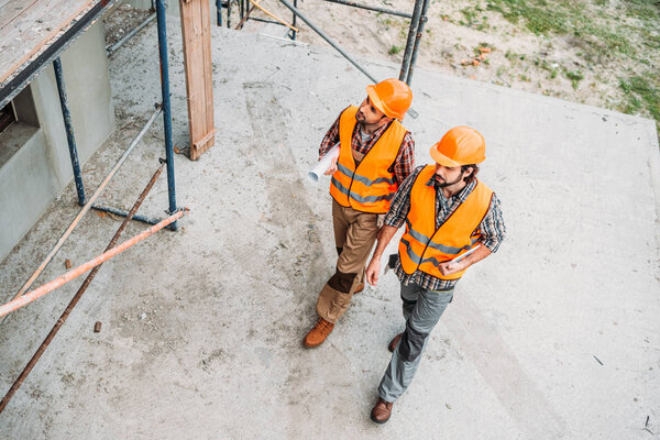 high angle view of builders walking at construction site