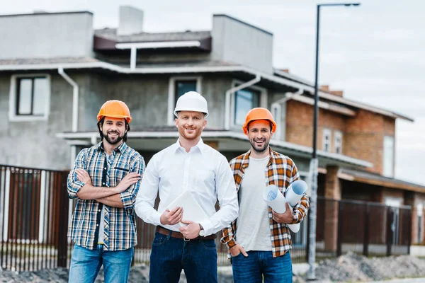 Group Smiling Architects Hard Hats Looking Camera Building Street — Stock Photo, Image