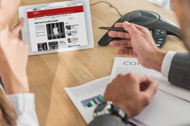 işadamı ve tablet, bbc Web sitesinde ekran bakarak işkadını kırpılmış