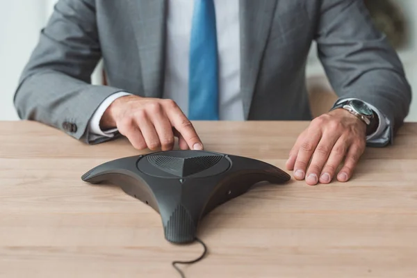 Cropped Shot Businessman Stylish Suit Pushing Button Conference Phone Workplace — Free Stock Photo