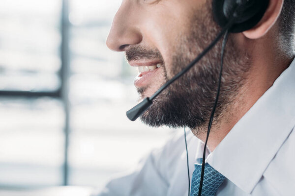 cropped shot of happy support hotline worker in white shirt at work