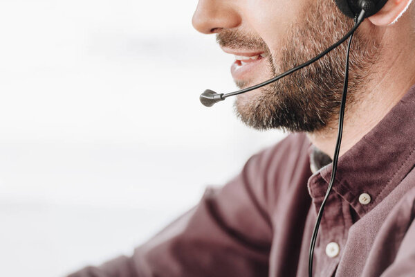 cropped shot of call center worker with microphone