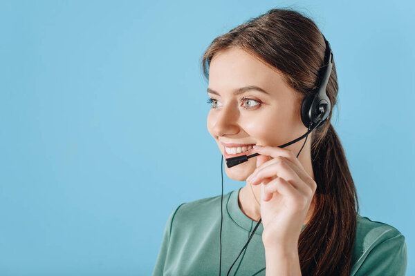 young smiling female support hotline worker isolated on blue