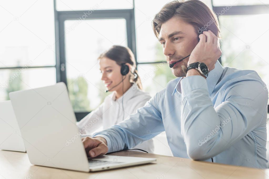 male and female call center managers working together at modern office