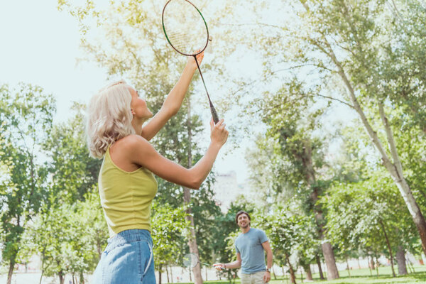 couple playing badminton outdoors in summer