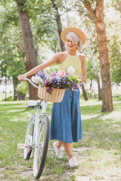 Красива Блондинка Гуляє Велосипедом Кошиком Квітів Парку — стокове фото