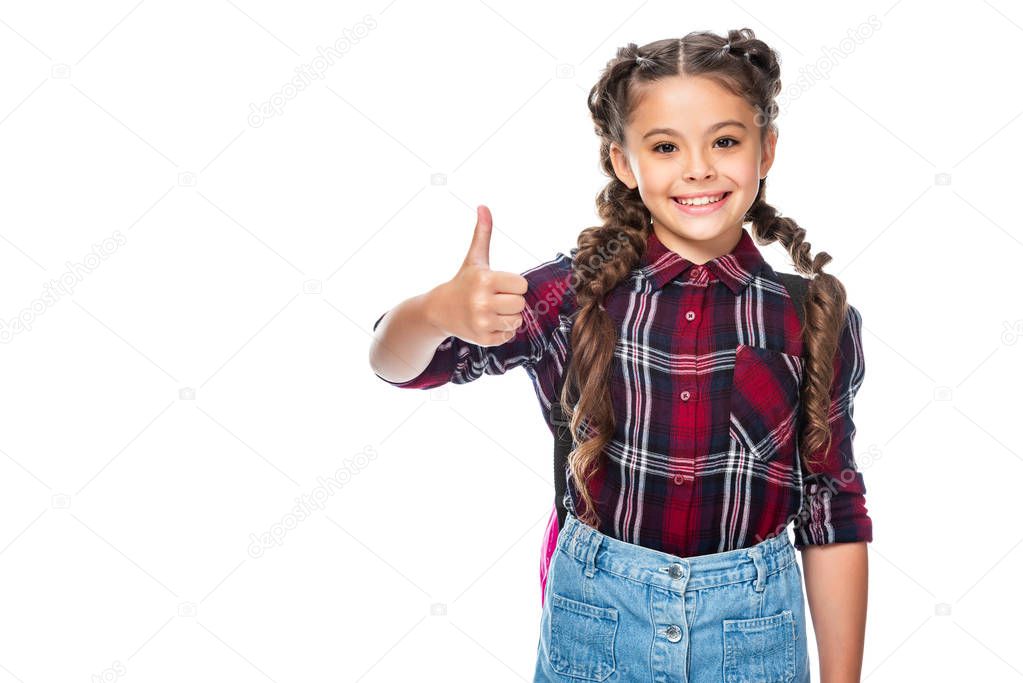 smiling schoolchild showing thumb up isolated on white