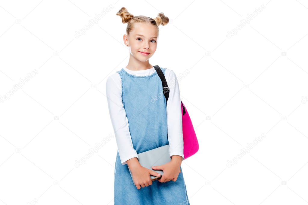schoolchild with pink backpack holding books and looking at camera isolated on white