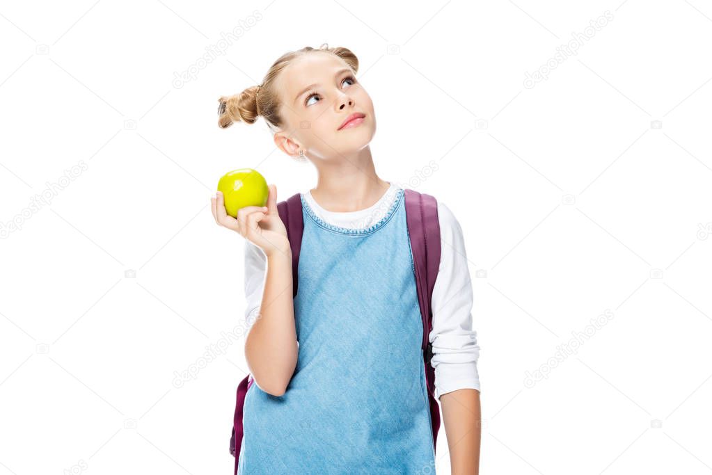 schoolchild holding apple and looking up isolated on white