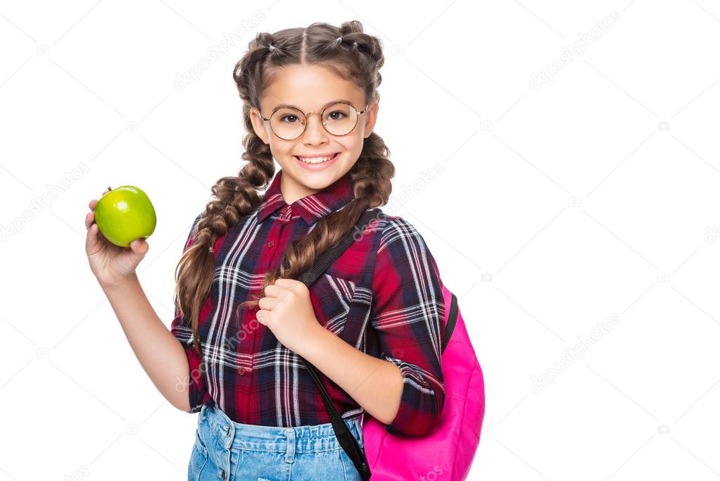 smiling schoolchild with backpack holding apple isolated on white
