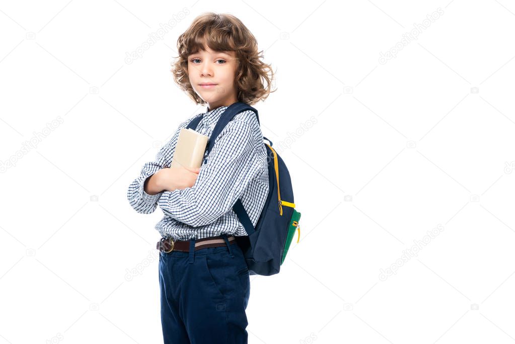 schoolboy hugging book and looking at camera isolated on white