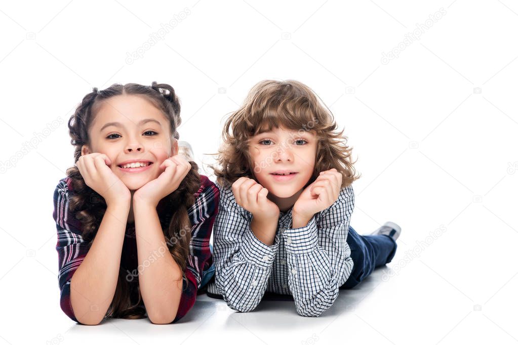 classmates resting chins on hands and looking at camera isolated on white