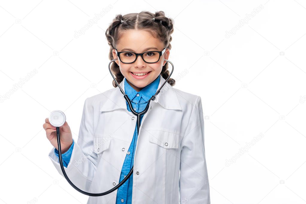 schoolchild in costume of doctor listening with stethoscope isolated on white