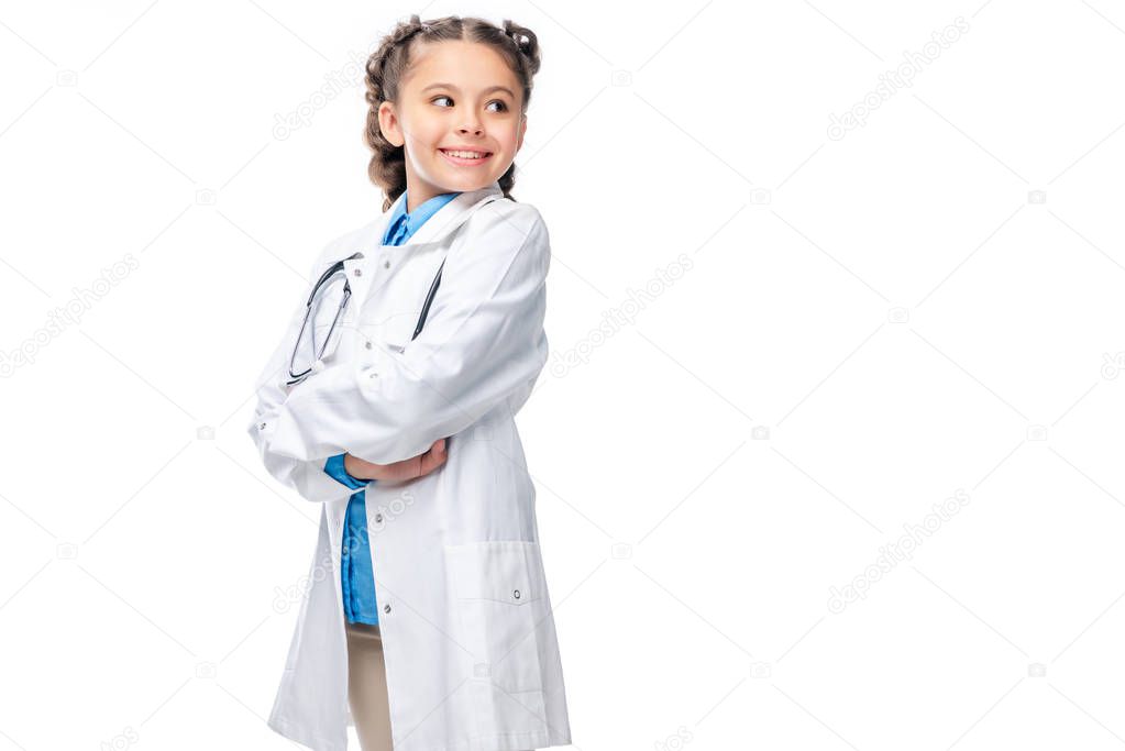 schoolchild in costume of doctor standing with crossed arms isolated on white