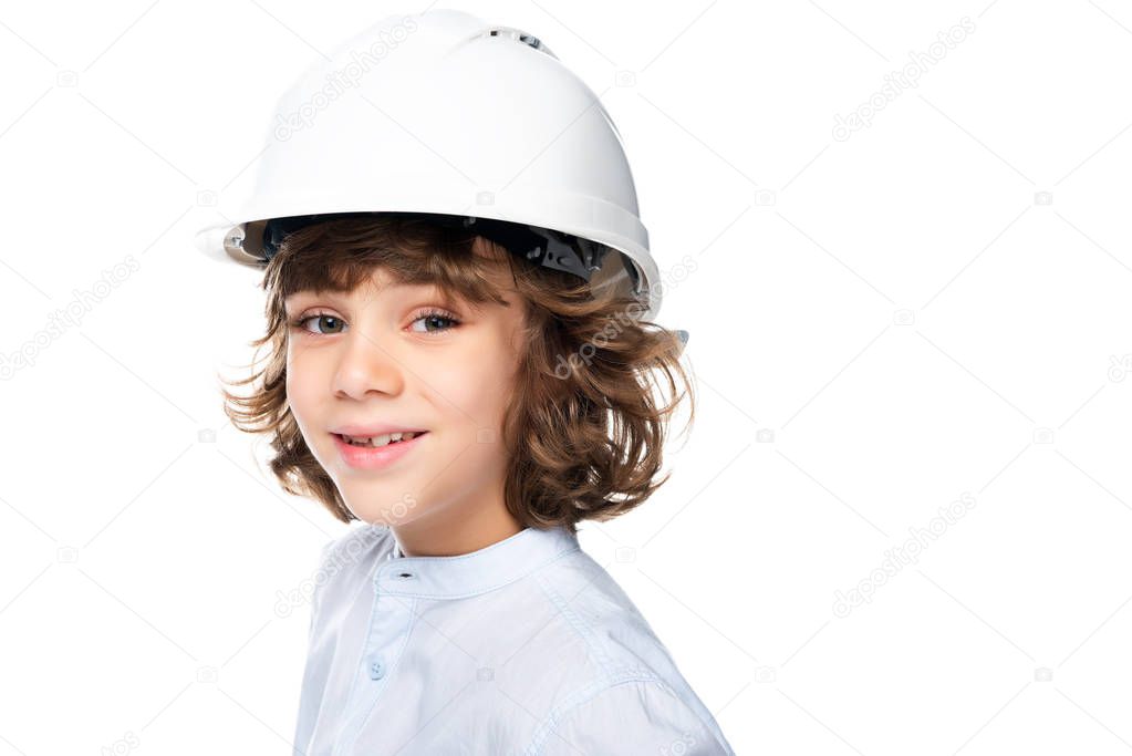 portrait of schoolboy in costume of architect and helmet isolated on white