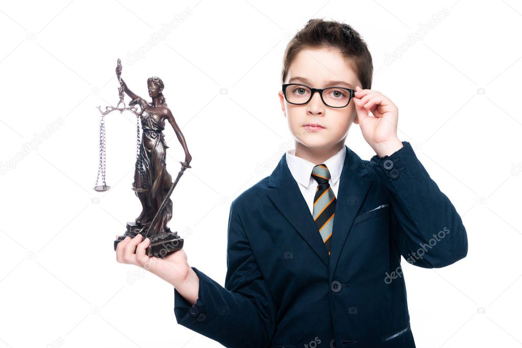 schoolboy in costume of lawyer holding themis statue and touching glasses isolated on white
