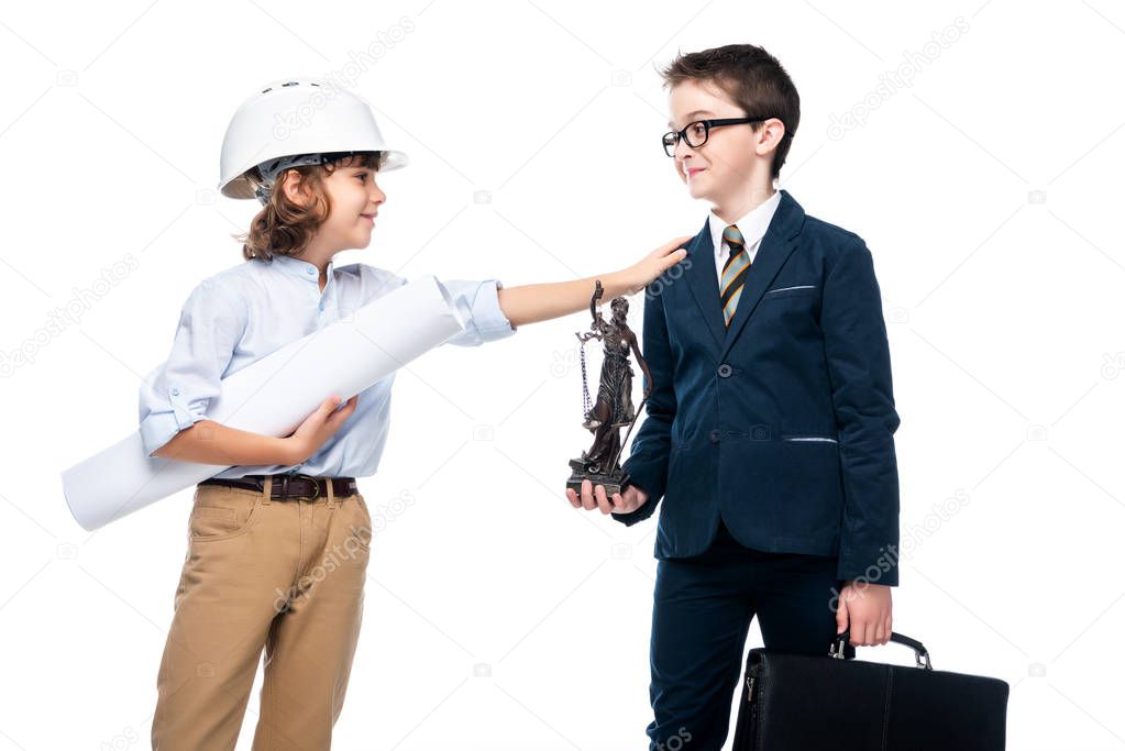 schoolboy in costume of architect touching lawyer isolated on white