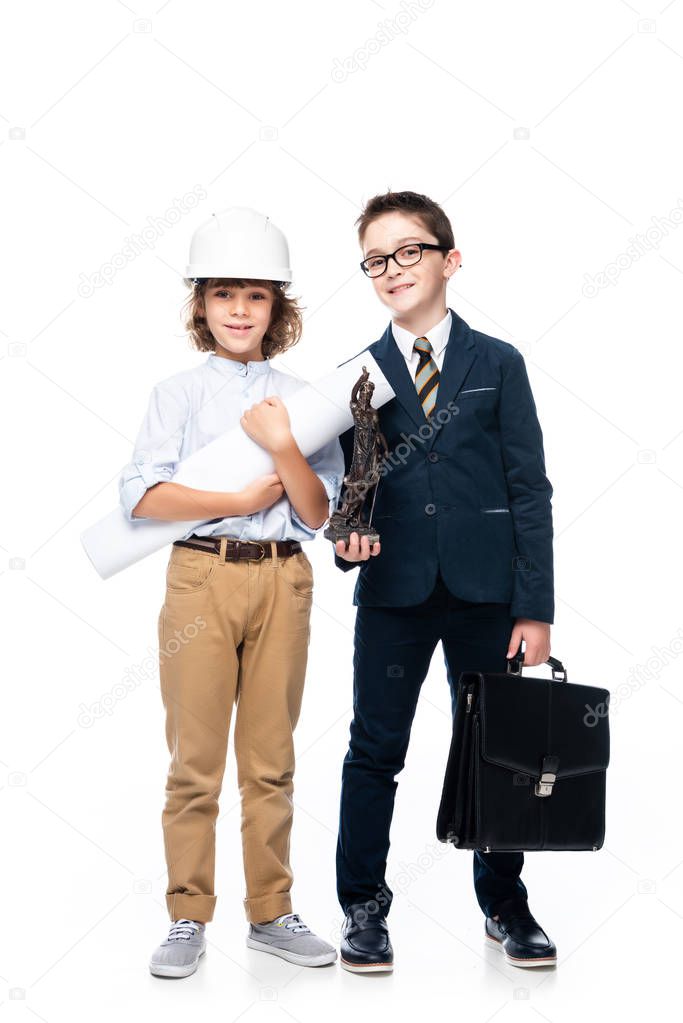 schoolboys in costumes of architect and lawyer looking at camera isolated on white