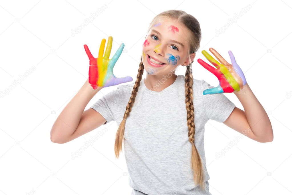 smiling schoolchild showing colored painted hands isolated on white