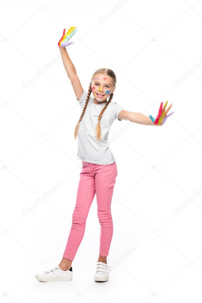 smiling schoolchild standing with painted open arms isolated on white and looking at camera