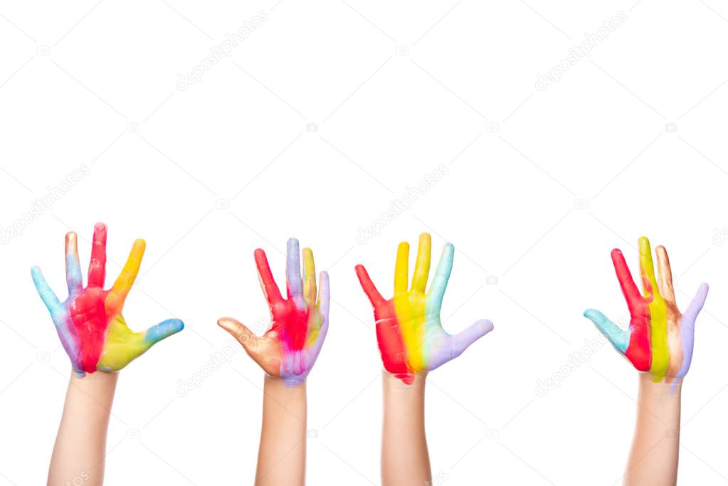 cropped image of schoolchildren showing painted colorful hands isolated on white
