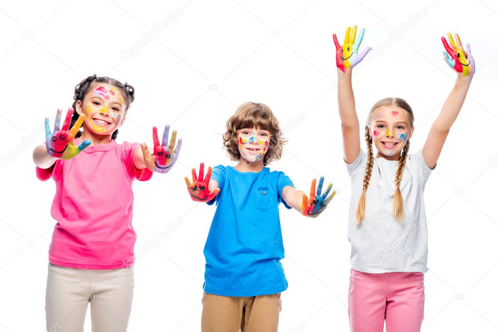 three classmates having fun and showing painted hands with smiley icons isolated on white