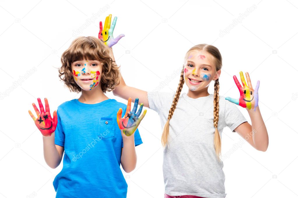 two classmates having fun and showing painted hands with smiley icons isolated on white