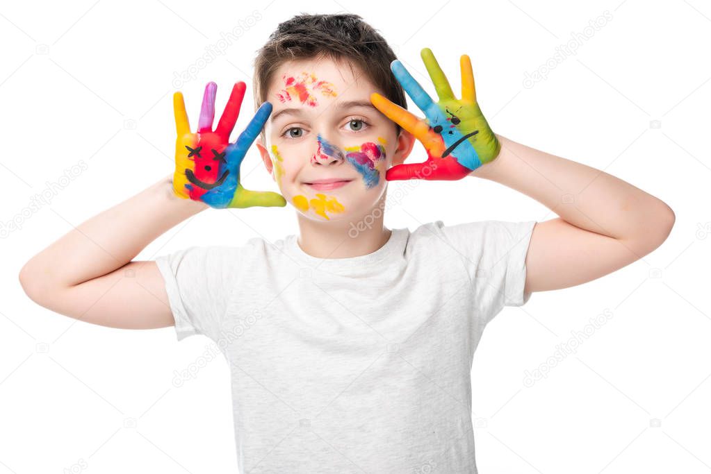 adorable schoolboy showing painted hands with smiley icons isolated on white