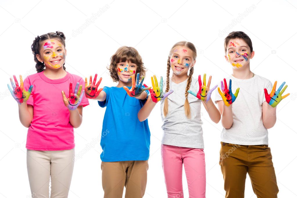 schoolchildren showing painted hands with smiley icons isolated on white