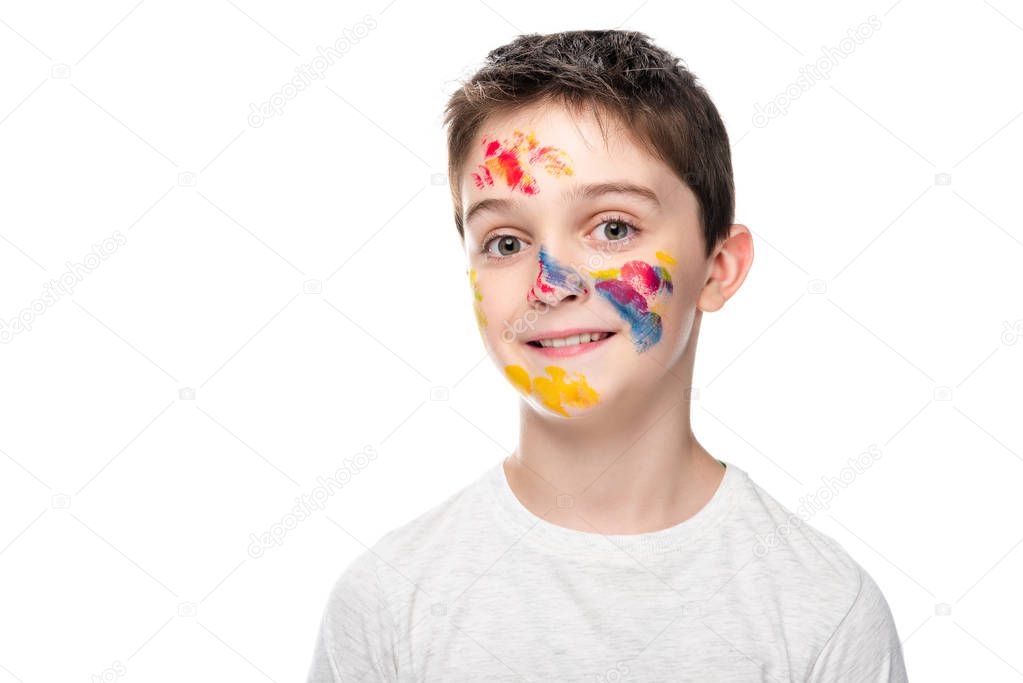 schoolboy with paints on face looking at camera isolated on white