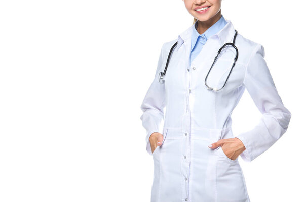 cropped view of smiling doctor posing in white coat with stethoscope, isolated on white