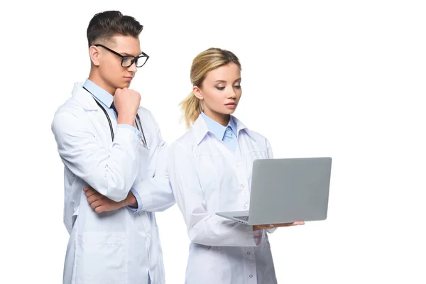 Young Pensive Doctors White Coats Using Laptop Isolated White — Free Stock Photo