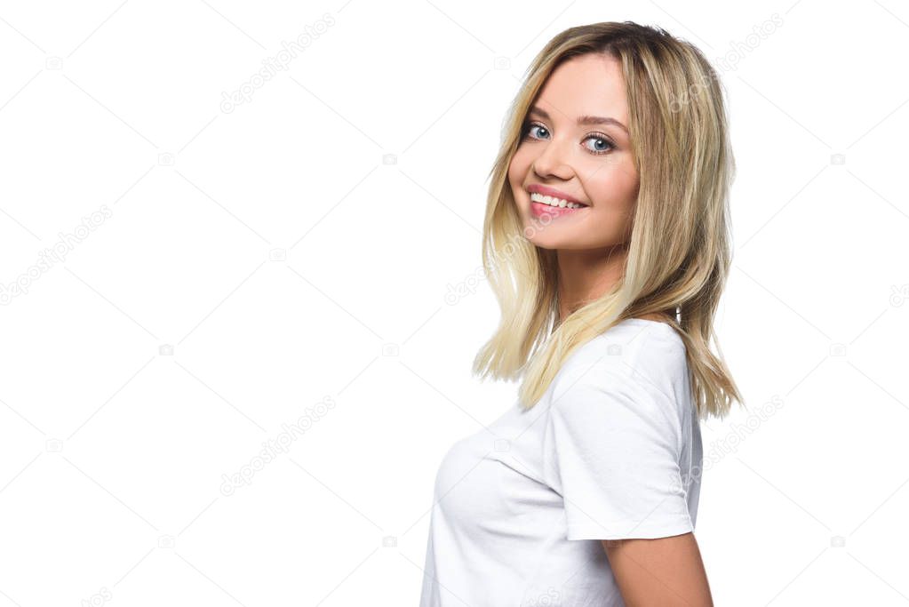portrait of smiling attractive girl in white shirt looking at camera isolated on white