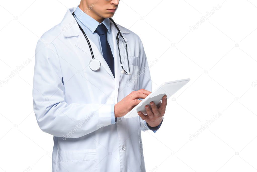 cropped shot of young doctor using tablet isolated on white