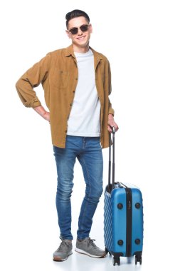 handsome young man with luggage looking at camera isolated on white clipart