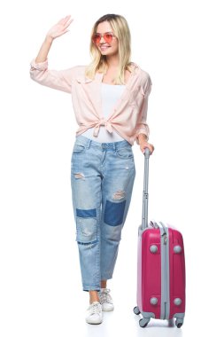 young travelling woman with luggage waving wih hand isolated on white clipart