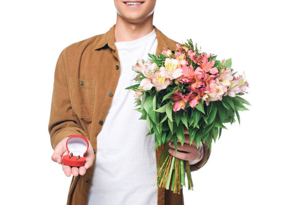 cropped shot of smiling young man with bouquet making proposal isolated on white