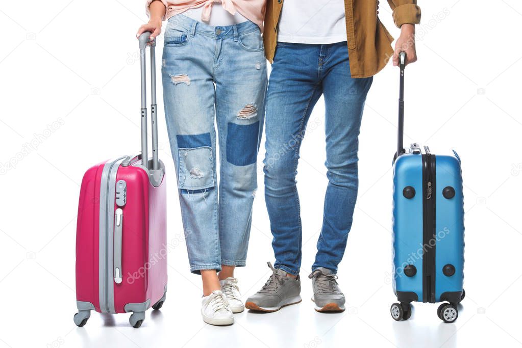 cropped shot of travelling couple with suitcases isolated on white