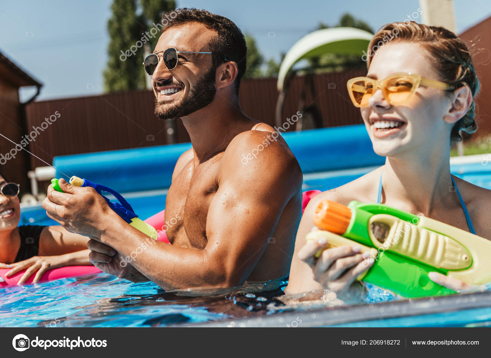 Couple Sunglasses Playing Water Guns Swimming Pool — Stock Photo