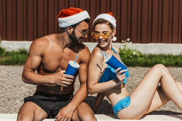 Beautiful Happy Couple Swimsuits Santa Hats Sunglasses — Stock Photo, Image