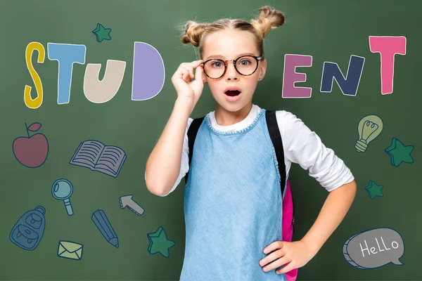 Shocked Schoolchild Touching Glasses Looking Camera Blackboard Icons Student Lettering — Stock Photo, Image