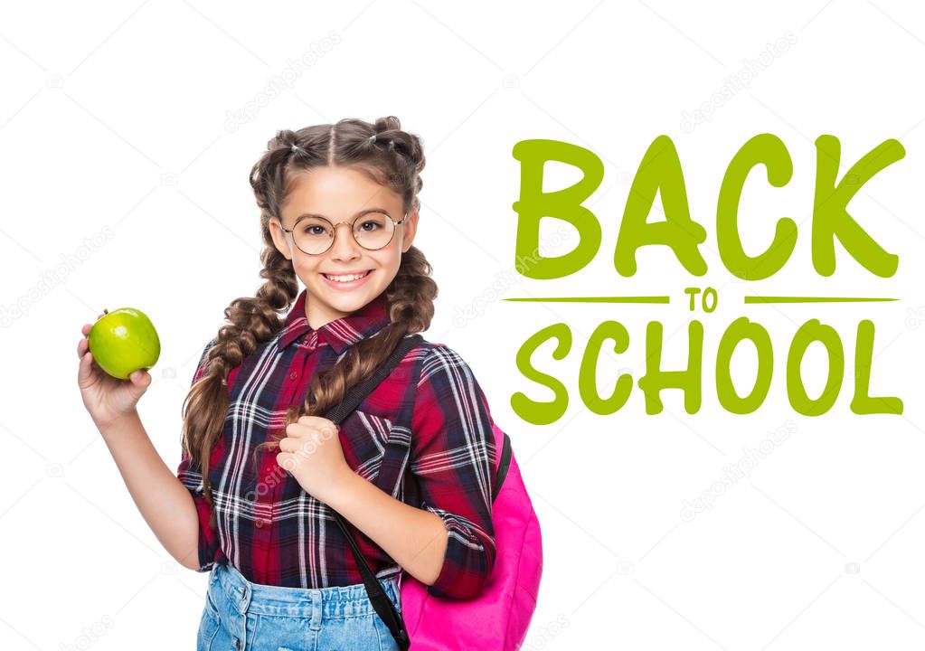 smiling schoolchild with backpack holding apple isolated on white, with 