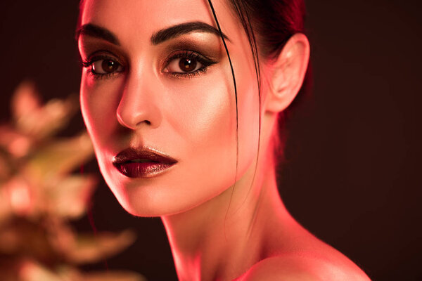 portrait of beautiful girl with makeup, red toned picture