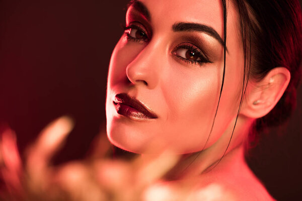 portrait of attractive model posing for fashion shoot, red toned picture
