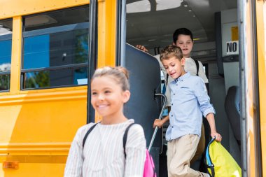 adorable scholars going out of school bus clipart