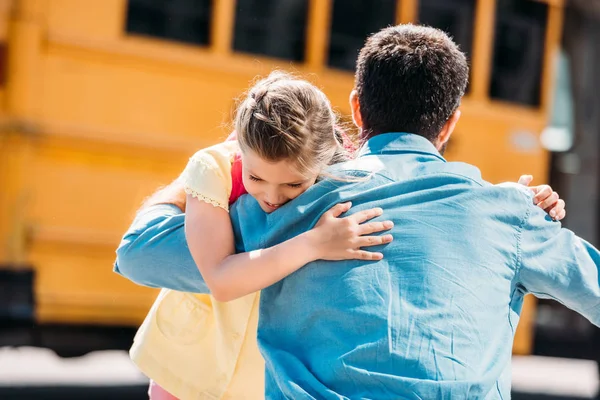 Rear View Father Daughter Embracing Front School Bus — Stock Photo, Image