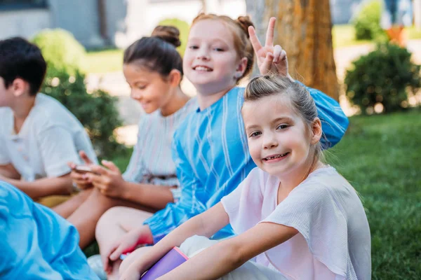 Group Adorable Schoolgirls Sitting Grass Looking Camera — Stock Photo, Image
