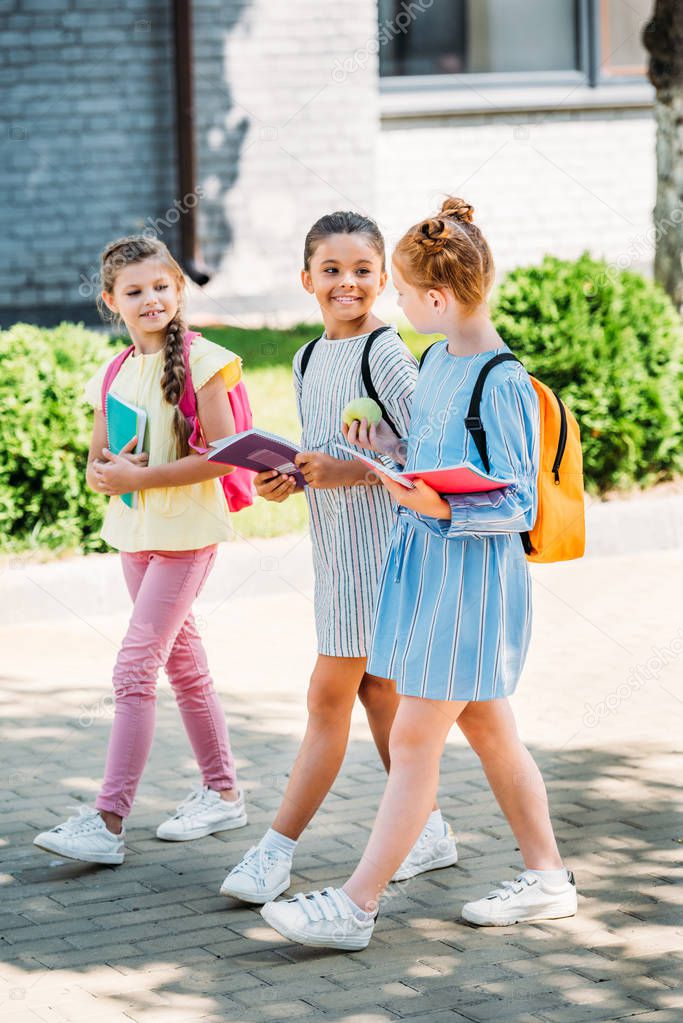 group of beautiful schoolgirls walking together after school