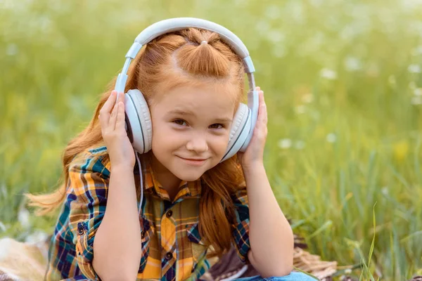 Portrait Smiling Kid Listening Music Headphones Green Grass Background — Stock Photo, Image
